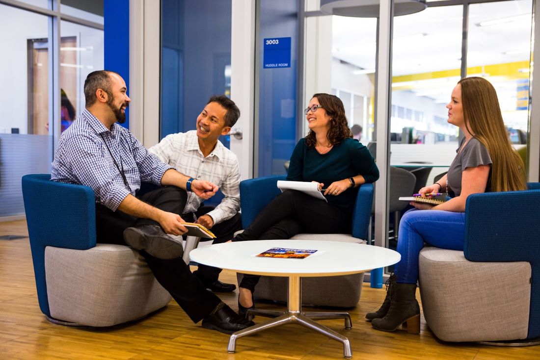 A group of UCPath employees collaborating in the office.