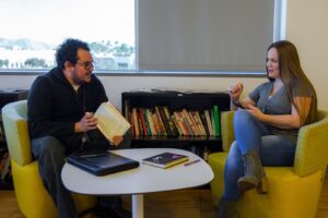 Two employees participating in a book club at UCPath